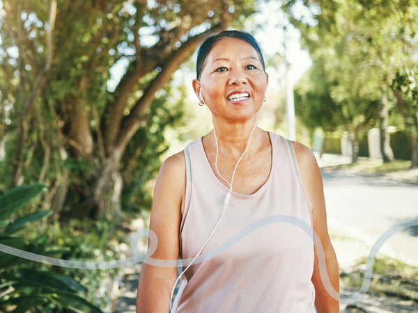 Woman with earphones outdoors in a park