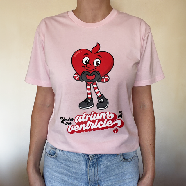 Person wearing a pink t-shirt with a cartoon heart design and text.