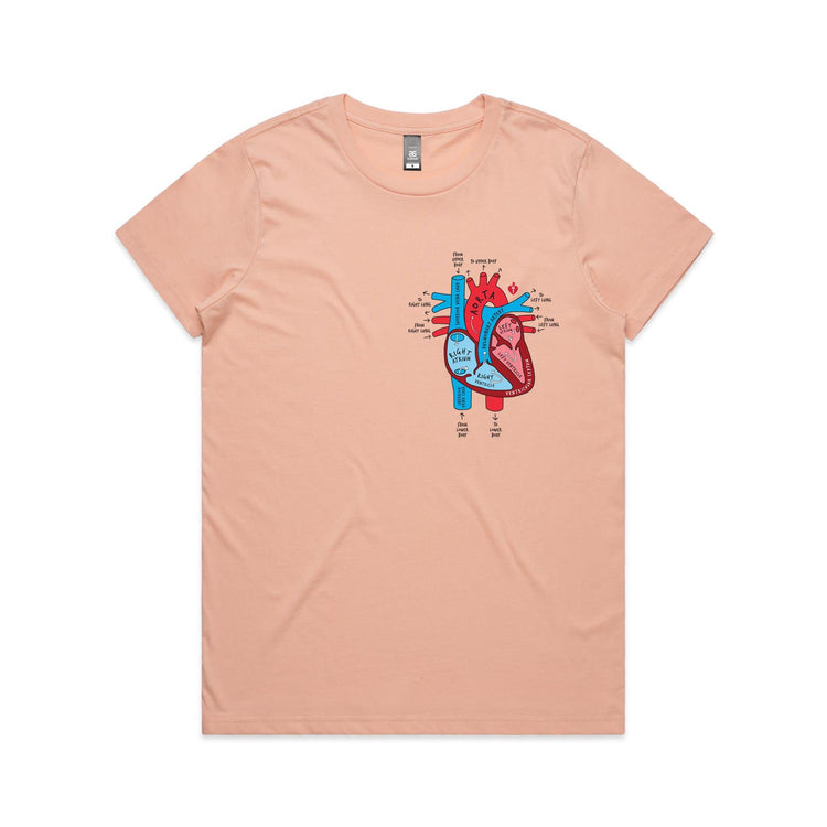 Women's pale pink t-shirt with colourful anatomical heart drawing on left chest displayed on white background.