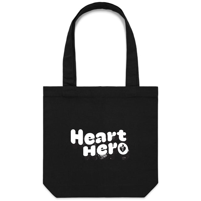 Heart Foundation black canvas tote bag shown with vintage look Heart hero text in white print on the front