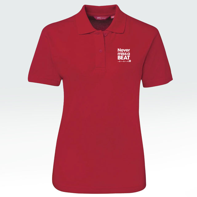 Heart Foundation women's red polo shirt featuring white embroidered 'Never miss a BEAT' tag line.