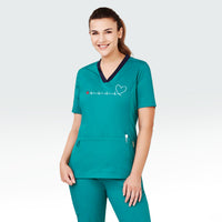 Model wearing women's teal scrub top featuring heartbeat line across front chest ending with stylised heart shape and incorporating Heart Foundation brand mark.