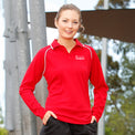 Young woman in outdoor setting modelling Heart Foundation Walking's red long sleeved polo shirt, showing white collar accents on raglan sleeve seam and collar.