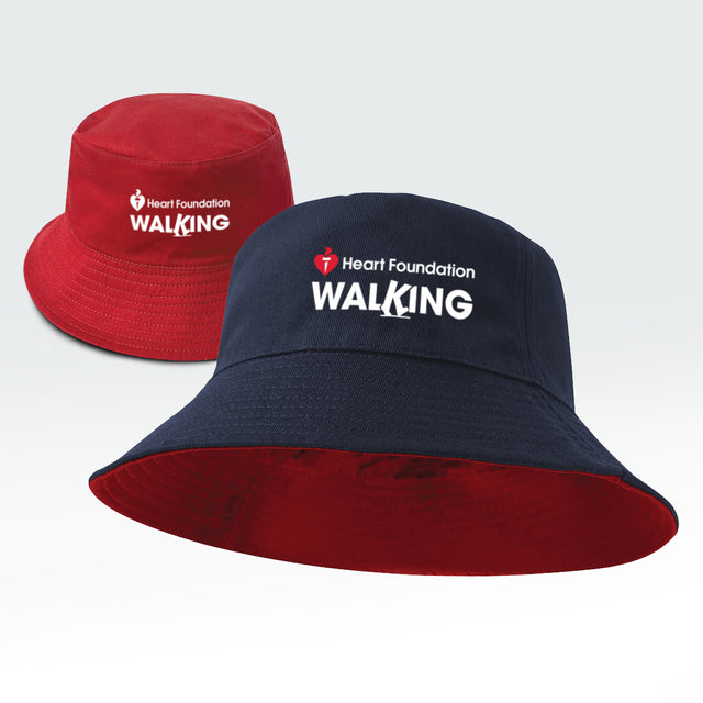 Reversible bucket hat, one side red and one side navy with 'Heart Foundation Walking' text, featured on a light gray background.