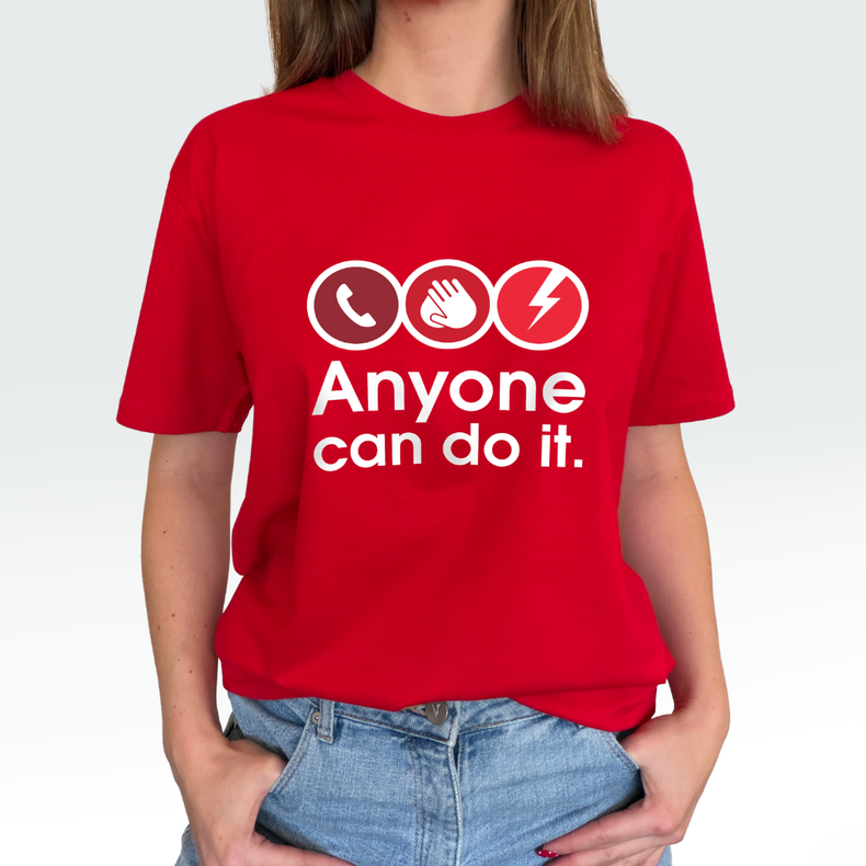 A woman wearing a bright red short-sleeve t-shirt with a white graphic print that reads 'Anyone can do it.' above three circular icons showing a telephone, a hand, and a lightning bolt.