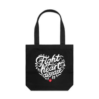 Black tote bag with a white heart-shaped “Fight heart disease” design, featured on white background.