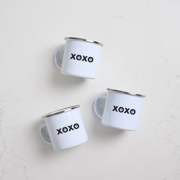 Heart Foundation white enamel mug with silver rim and XOXO design in black print
